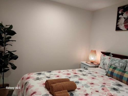 a bedroom with a bed with a comforter on it at Lux 2 Bed 2 Bath Secure Parking Apartment in the Heart of Dickson, Canberra in Canberra