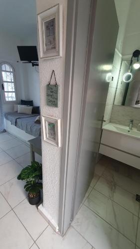 a room with a bed and a clock on a wall at Nikol studio 2 in Kallithea Halkidikis