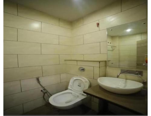a bathroom with a toilet and a sink at HOTEL SHRI RAM RESIDENCY, Agra in Agra