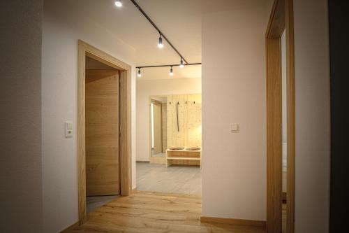 a hallway with a door leading to a bedroom at WOLF Apartments Padaun in Vals