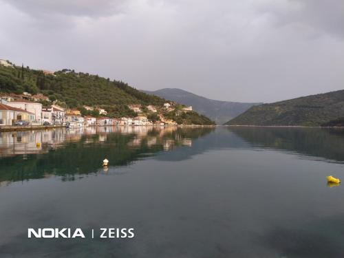 a large body of water with houses and mountains at BARRACKS 1856 in Vathi, Ithaka