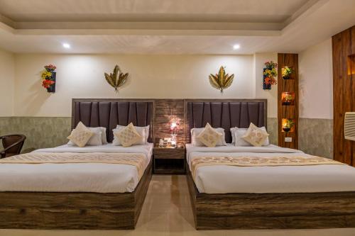 a hotel room with two beds and a fireplace at Hotel Mahajan International, Delhi Airport in New Delhi