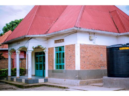 a red roofed building with a red roof at Planete Hotel in Rubavu
