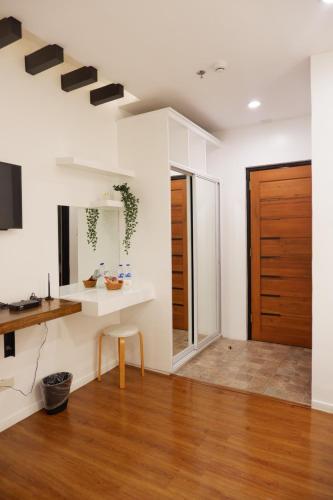 a living room with white walls and a wooden door at ECCO Suites Baguio in Baguio