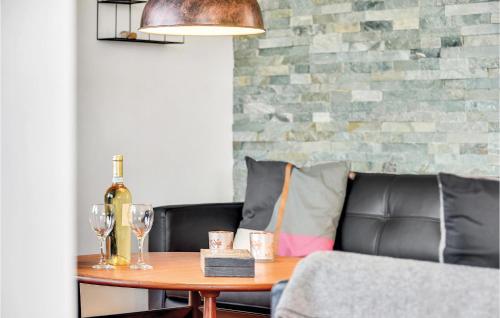 a table with a bottle of wine and glasses on a couch at Three-Bedroom Holiday Home In Augustenborg in Augustenborg