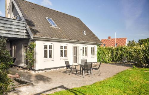 a house with a table and chairs in the yard at Holiday Home Nr Landevej Sydals Xi in Kegnæshøj