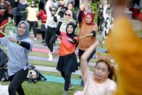 a group of people doing yoga in the grass at Metland Hotel Cirebon in Cirebon
