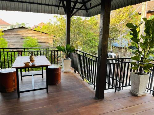 a patio with a table and an umbrella at Roya Khmer House in Siem Reap