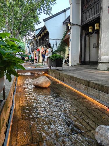 a rock in the water in a street at Hangzhou Lanshe hotel in Hangzhou