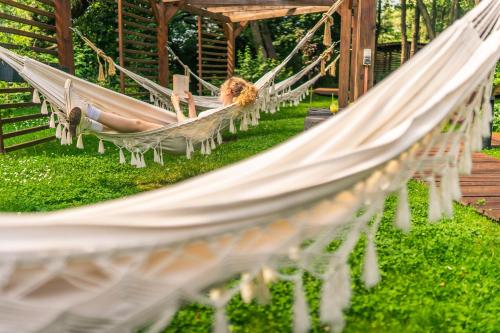 a group of hammocks in a garden at Baltic Natur Park - Holiday Resort in Niechorze