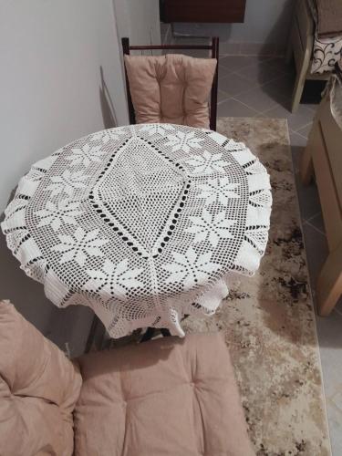 a white table with a white lace umbrella on it at Apartman Radoman in Cetinje