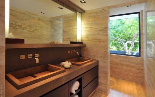a bathroom with a sink and a large window at Luxury Vacation Villa 13 in Pointe Milou