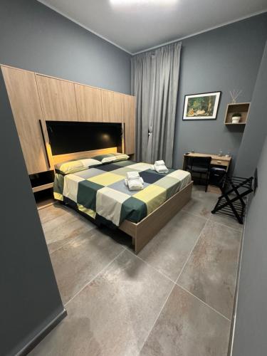 a bedroom with a large bed and a desk at B&B Parma Centro in Parma