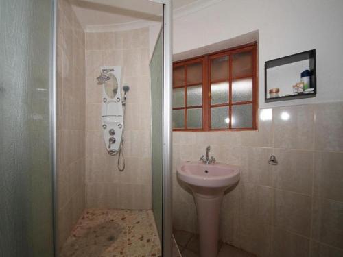 a bathroom with a shower and a sink at Bird Haven Guesthouse in Leribe