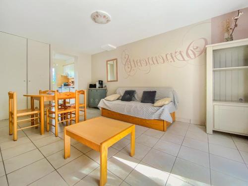 a bedroom with a bed and a table and a dining room at Résidence Les Iles in Pénestin