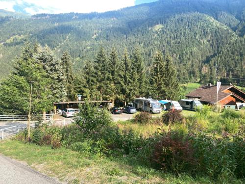 a group of vehicles parked in front of a mountain at Molltaler Appartements en b&b in Stall