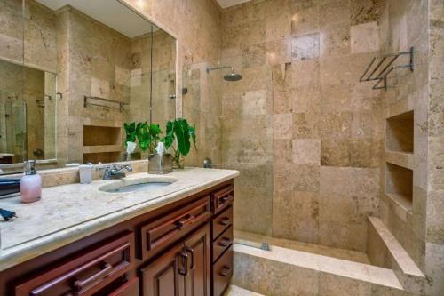 a bathroom with a sink and a shower at Beautiful and Comfortable Four Bedroom Villa in Cajuiles