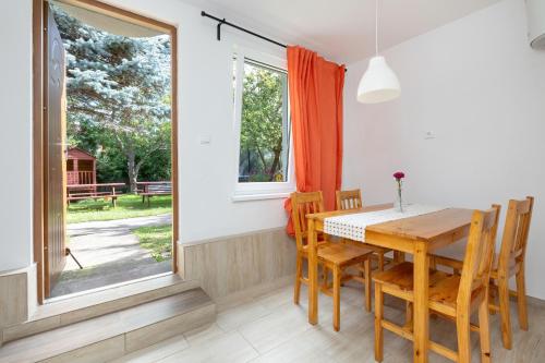 a dining room with a table and chairs and a window at Krab in Rewal