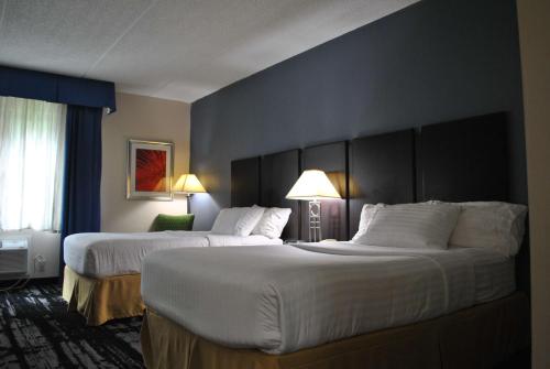a hotel room with two beds and two lamps at Best Western Owego Inn in Owego
