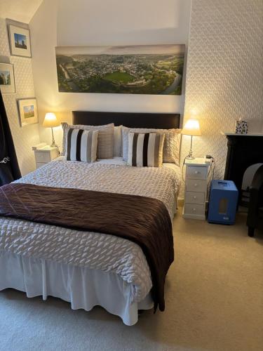 a bedroom with a large bed and a painting on the wall at Last Cottage in Richmond