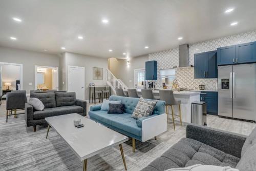 a living room with blue furniture and a kitchen at Baby Blue - Hot Tub Easy Access to Top Locations in Colorado Springs