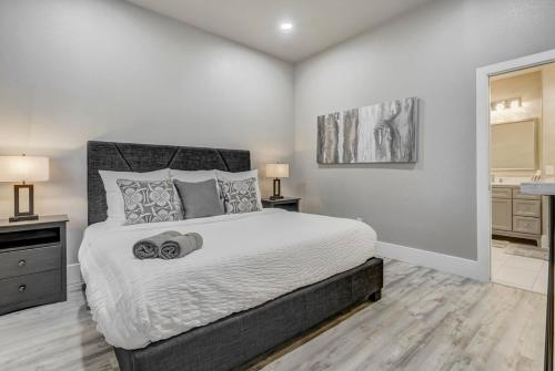 a bedroom with a large bed and a bathroom at Baby Blue - Hot Tub Easy Access to Top Locations in Colorado Springs