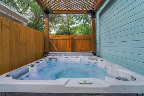 a hot tub in a backyard with a wooden fence at Baby Blue - Hot Tub Easy Access to Top Locations in Colorado Springs