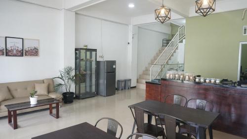 a living room with two tables and a couch at Safar Homestay Dekat JEC in Demangan