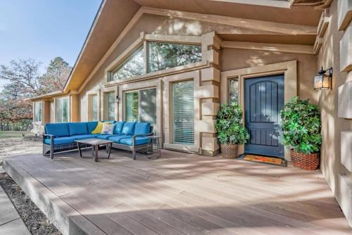 a patio with blue chairs and a table at Briarhaven Forest BBQ & Patio & Fast WiFi in Monument