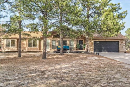 a house with a garage and trees in front of it at Briarhaven Forest BBQ & Patio & Fast WiFi in Monument