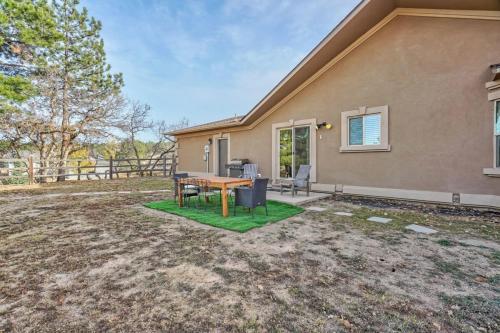 a house with a table and chairs in a yard at Briarhaven Forest BBQ & Patio & Fast WiFi in Monument