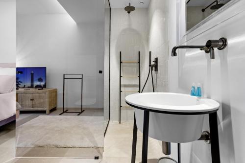 a white bathroom with a sink and a shower at villa 250 m² Vue mer Luxe parking in Grimaud