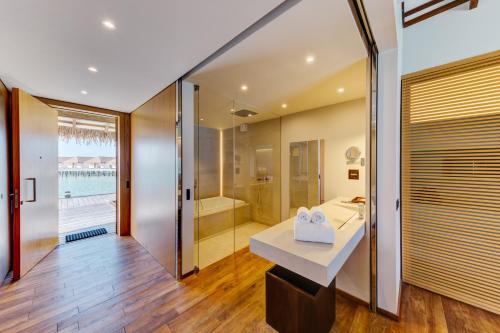 a bathroom with a sink and a shower and a tub at Cinnamon Velifushi Maldives in Felidhoo 