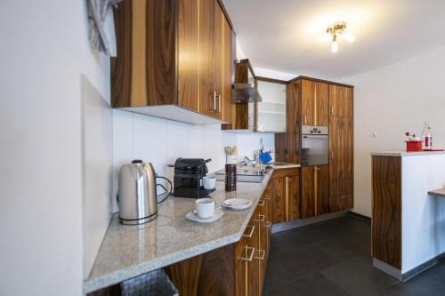 a kitchen with wooden cabinets and a counter top at Chasa Taverna Costa dad Archas Parterre in Sent