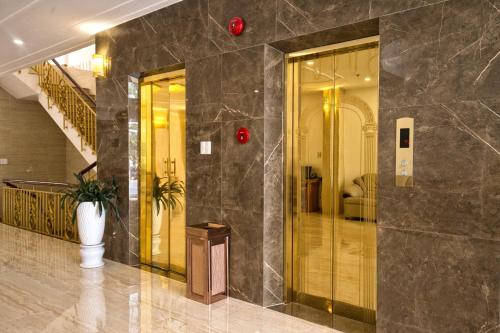 a lobby of a building with a staircase and a lobby at Le Centre Pleiku Hotel in Pleiku