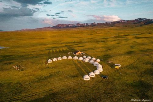 an aerial view of a farm in the middle of a field at Ulush Yurts in Naryn