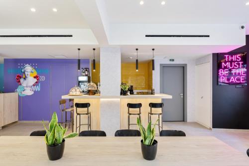 a kitchen with a table and some plants in a room at The Q Hotel in Athens