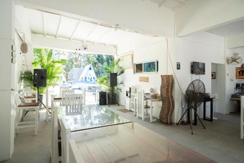 a living room with a glass table and chairs at Costas De Liwa Bar & Beach Resort in Zambales