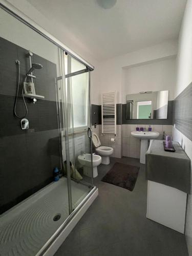 a bathroom with a shower and a toilet and a sink at Via Itria in Marsala
