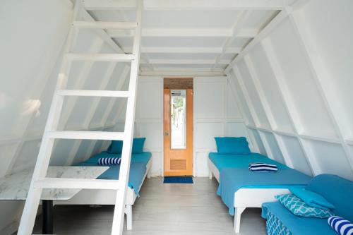 a room with two beds and a ladder at Costas De Liwa Bar & Beach Resort in Zambales