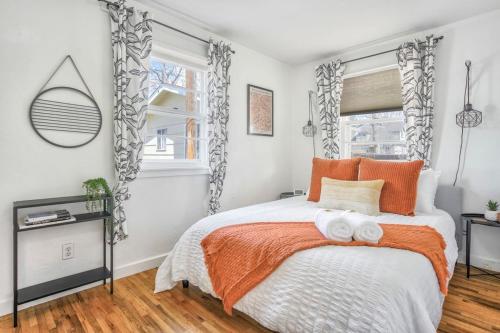 a bedroom with a bed with two towels on it at Colorado Cottage - Downtown King Scenic in Colorado Springs