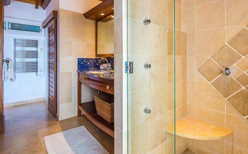 a bathroom with a shower and a sink at Luxury Vacation Villa 16 in Pointe Milou