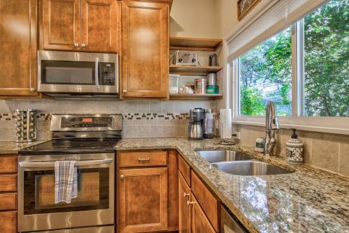 a kitchen with a sink and a microwave at Corona Victorian - Downtown Hot Tub Scenic View in Colorado Springs