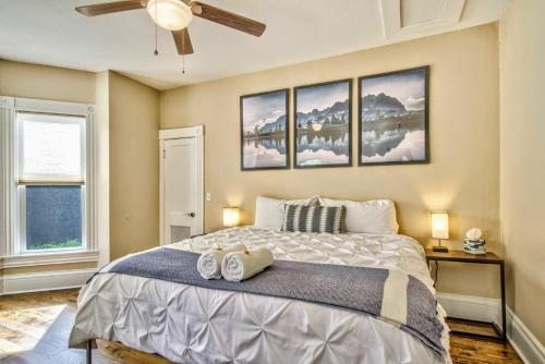 a bedroom with a bed with two towels on it at Corona Victorian - Downtown Hot Tub Scenic View in Colorado Springs