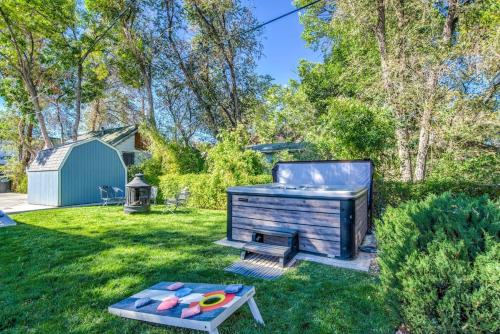 a backyard with a barbecue grill and a table at Corona Victorian - Downtown Hot Tub Scenic View in Colorado Springs