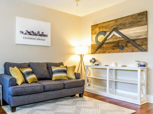 a living room with a couch and a table at Corona Cabana - Hot Tub BBQ Top Attractions in Colorado Springs
