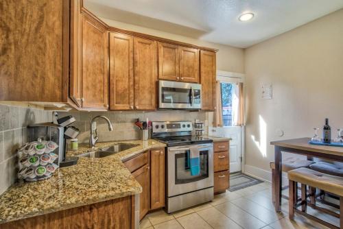 a kitchen with wooden cabinets and a stove top oven at Corona Cabana - Hot Tub BBQ Top Attractions in Colorado Springs