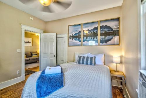 a bedroom with a bed and two paintings on the wall at Corona Cabana - Hot Tub BBQ Top Attractions in Colorado Springs