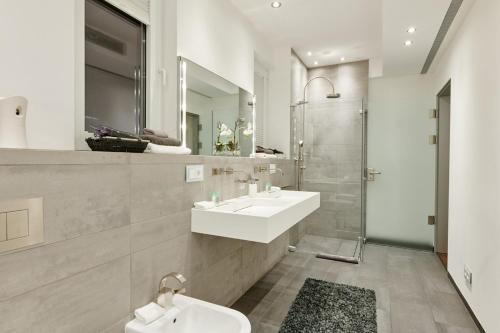 a bathroom with two sinks and a shower at Casa Minnustras - Santa Eulalia in Santa Eularia des Riu
