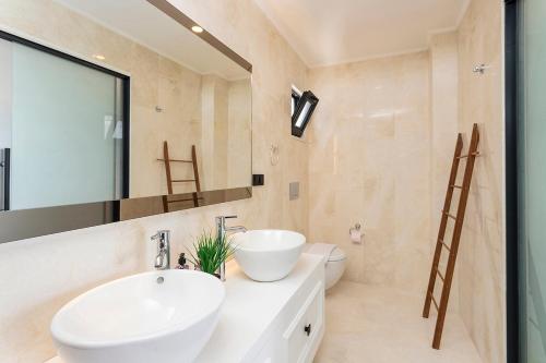 a bathroom with a sink and a mirror at Tashan Villas in Kas